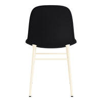 Black chair with a smooth surface and contrasting light wood legs, showcasing a modern and minimalist design.