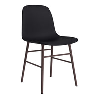 Black chair with a smooth finish and brown metal legs, featuring a minimalist design suitable for modern decor.