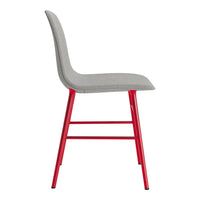 Gray upholstered chair with vibrant red metal legs, featuring a sleek and modern design.