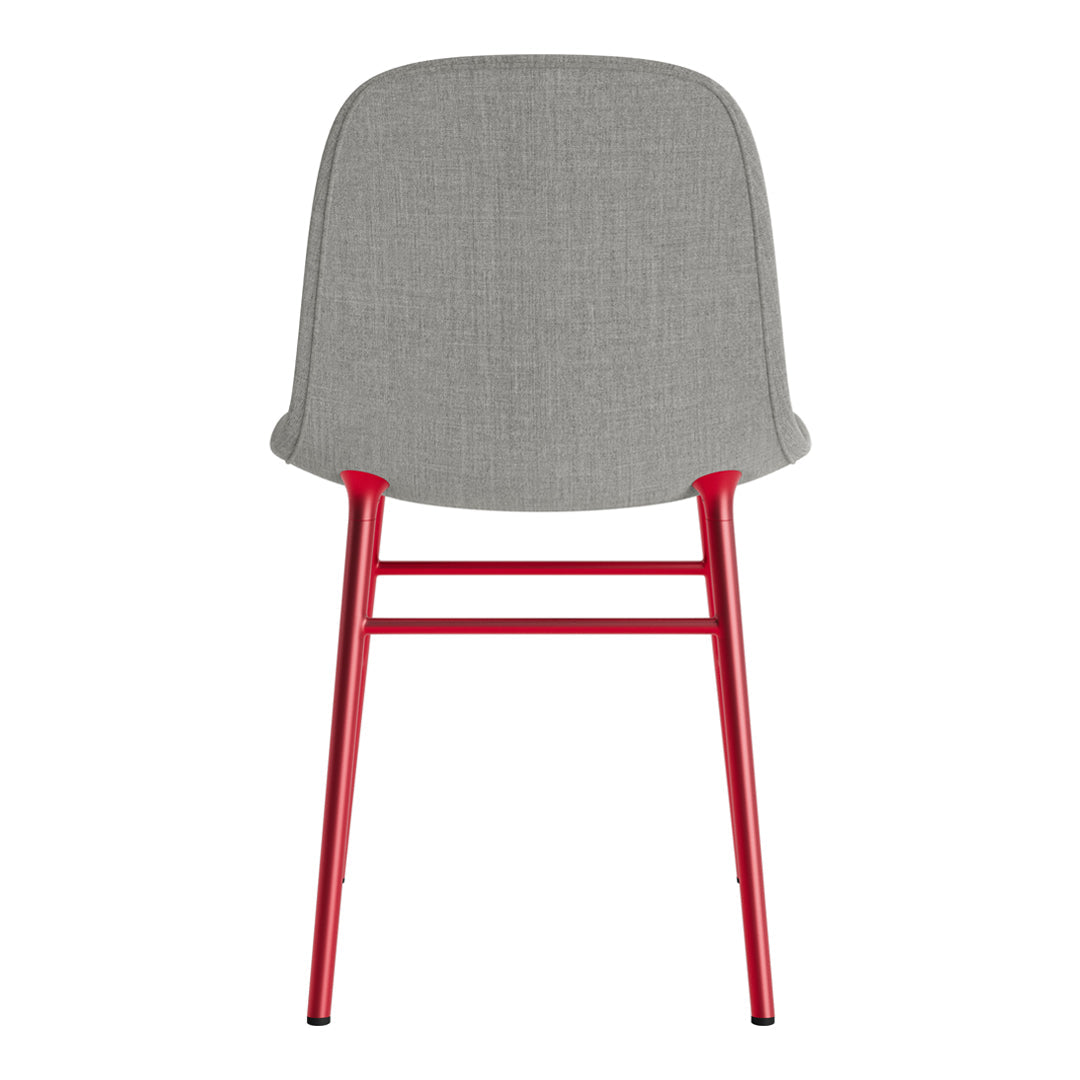 Gray upholstered chair with a sleek red metal frame, modern design, and minimalistic style.