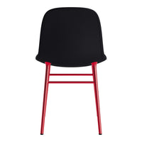 Black chair with smooth curves and bold red metal legs, creating a striking modern contrast.