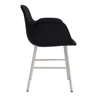 Modern black upholstered chair with sleek silver legs, showcasing a minimalist design and subtle curves.
