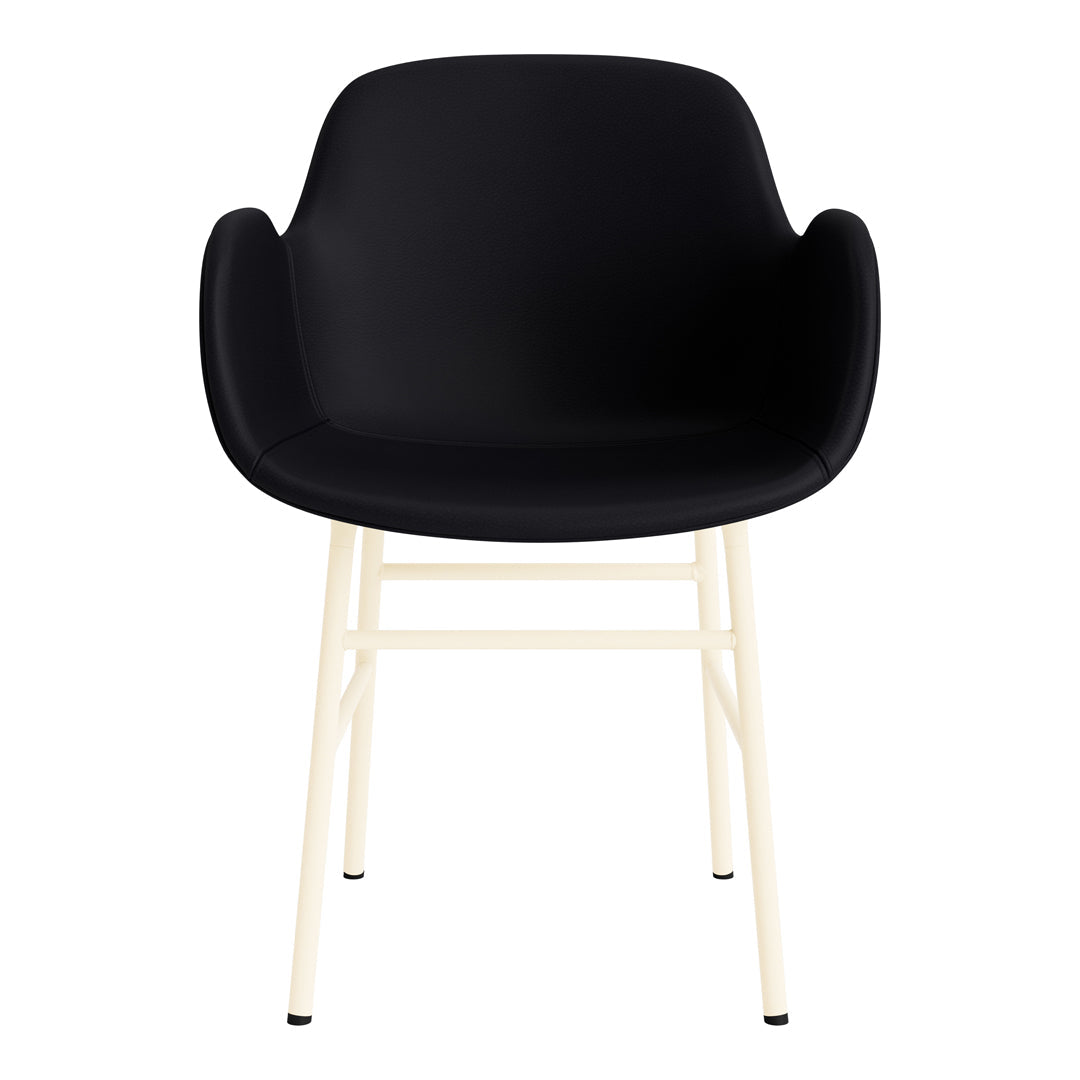 Black molded chair with cream-colored metal legs, featuring a sleek and modern design. Perfect for contemporary decor.