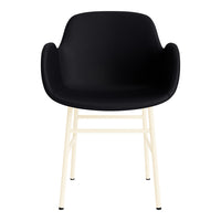 Black molded chair with cream-colored metal legs, featuring a sleek and modern design. Perfect for contemporary decor.