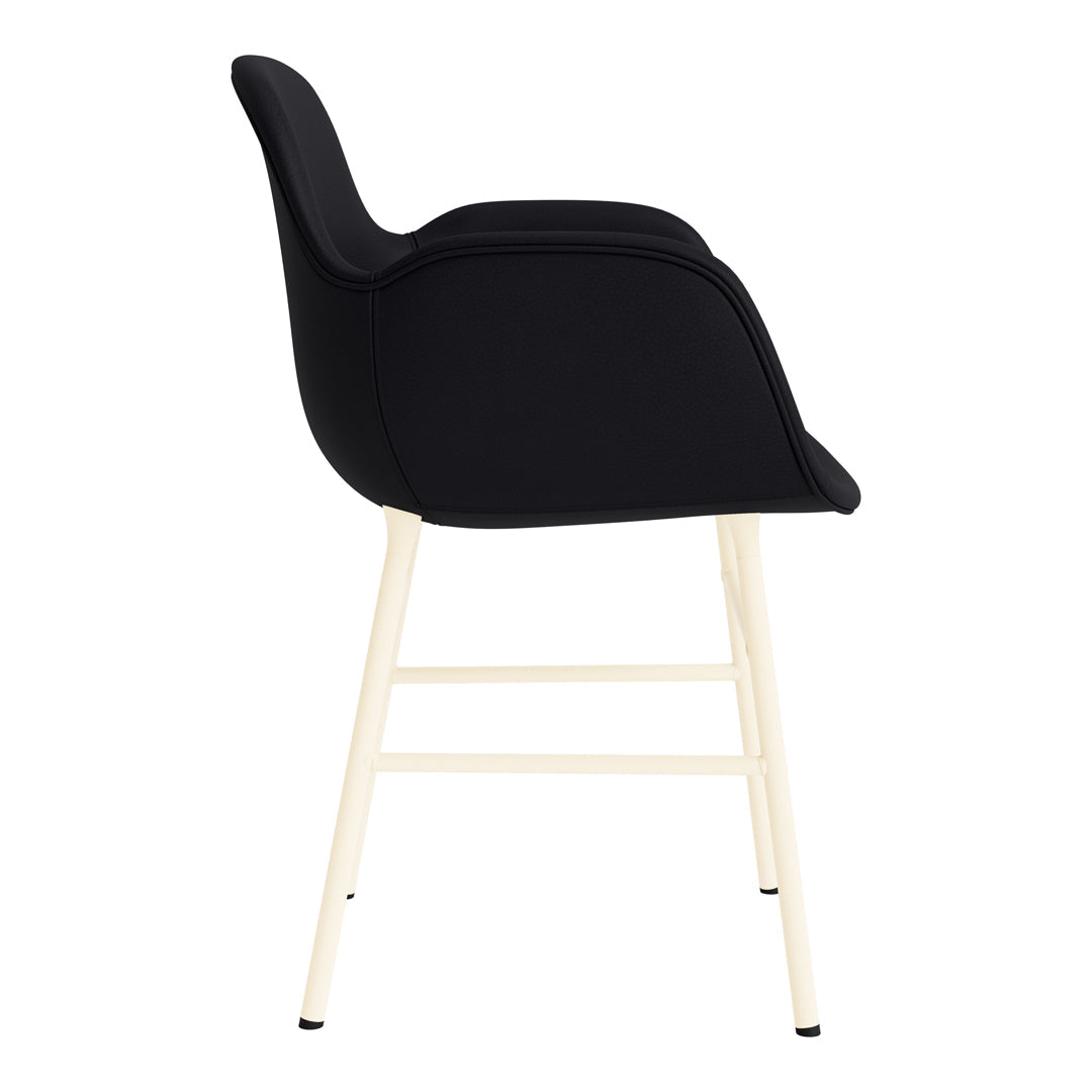 Black upholstered chair with minimalist design and creamy white legs, highlighting modern style and contrast.