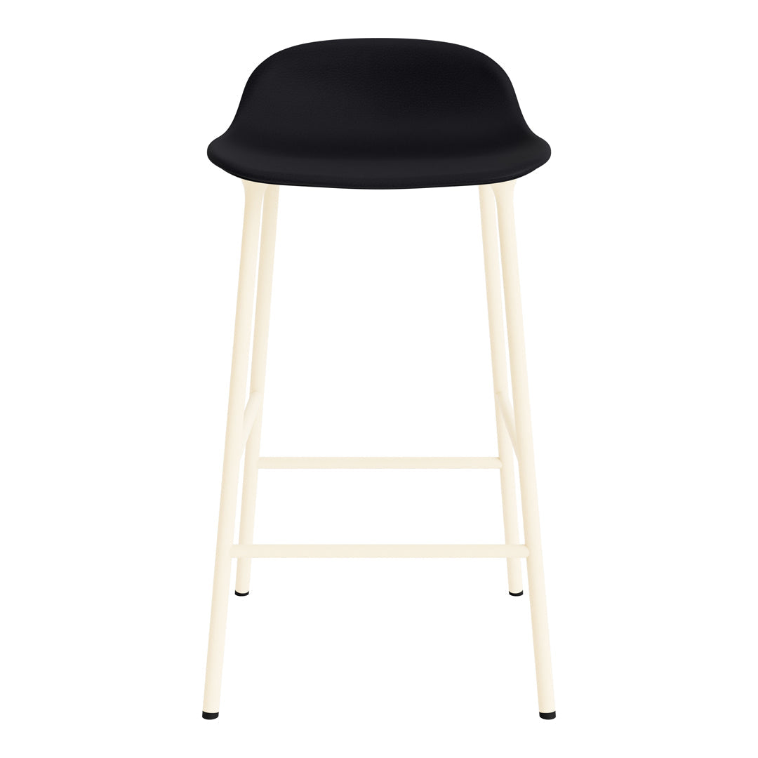 Black modern bar stool with a sleek molded seat and light cream-colored legs. Minimalist design with a stylish contrast.