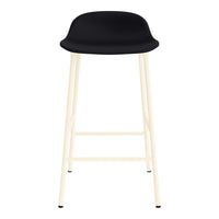 Black modern bar stool with a sleek molded seat and light cream-colored legs. Minimalist design with a stylish contrast.