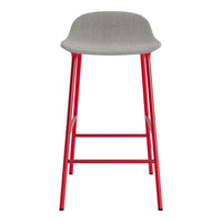 Gray upholstered barstool with vibrant red metal legs, featuring a sleek, modern design.