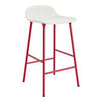 White bar stool with a textured seat and bold red metal legs, perfect for modern decor.