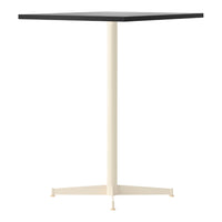 Black square tabletop on a cream-colored pedestal base, sleek and modern design for contemporary spaces.