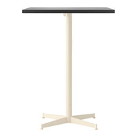 Black square table top with a cream-colored metal base and four-legged design. Modern and minimalist style.