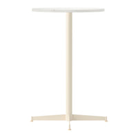 Round white tabletop with a sleek, cream-colored metal base in a minimalist design. Perfect for modern spaces.