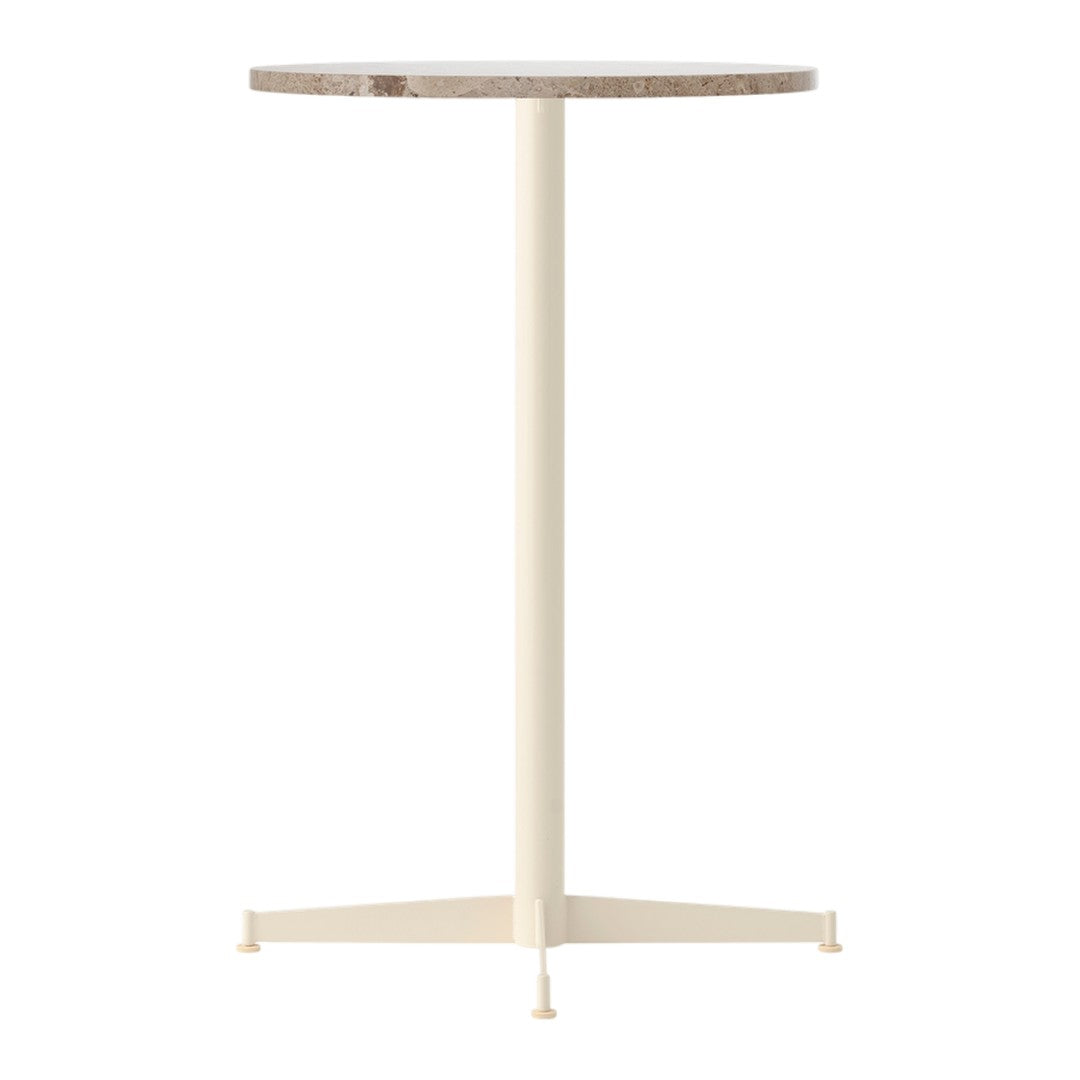 Light cream pedestal table with a textured brown circular top. Modern and minimal design.