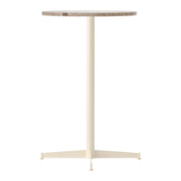 Light cream pedestal table with a textured brown circular top. Modern and minimal design.