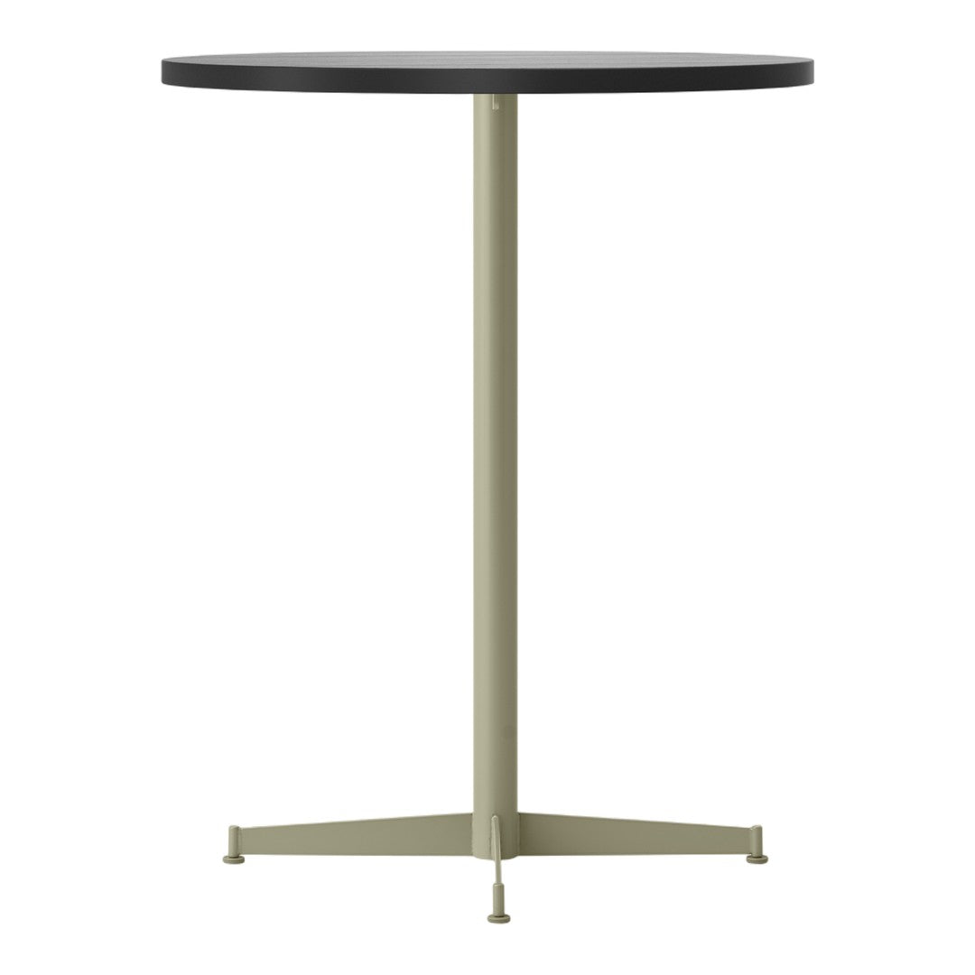 Round black tabletop with a muted green base, featuring a sleek, minimalist design and modern color contrast.