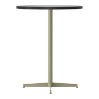 Round black tabletop with a muted green base, featuring a sleek, minimalist design and modern color contrast.