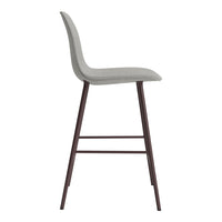 Gray upholstered bar stool with a sleek, minimalist design and dark wooden legs. Ideal for modern spaces.