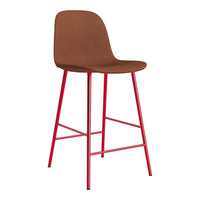 Brown upholstered bar stool with vibrant red legs, featuring a sleek, minimalist design.