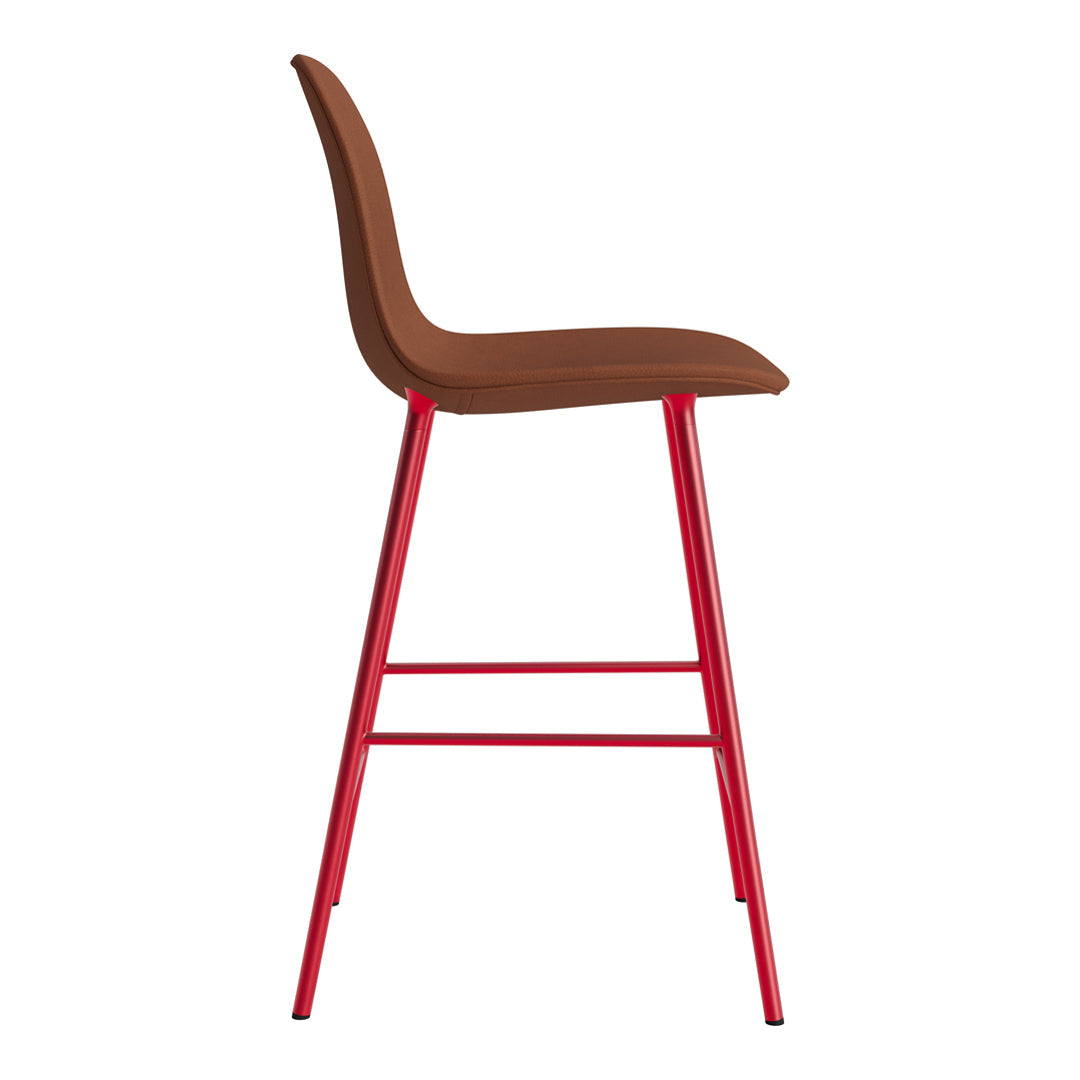 Brown upholstered bar stool with sleek red metal legs, featuring a minimalist design.