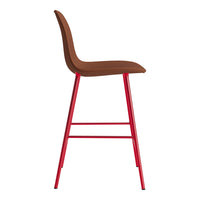 Brown upholstered bar stool with sleek red metal legs, featuring a minimalist design.