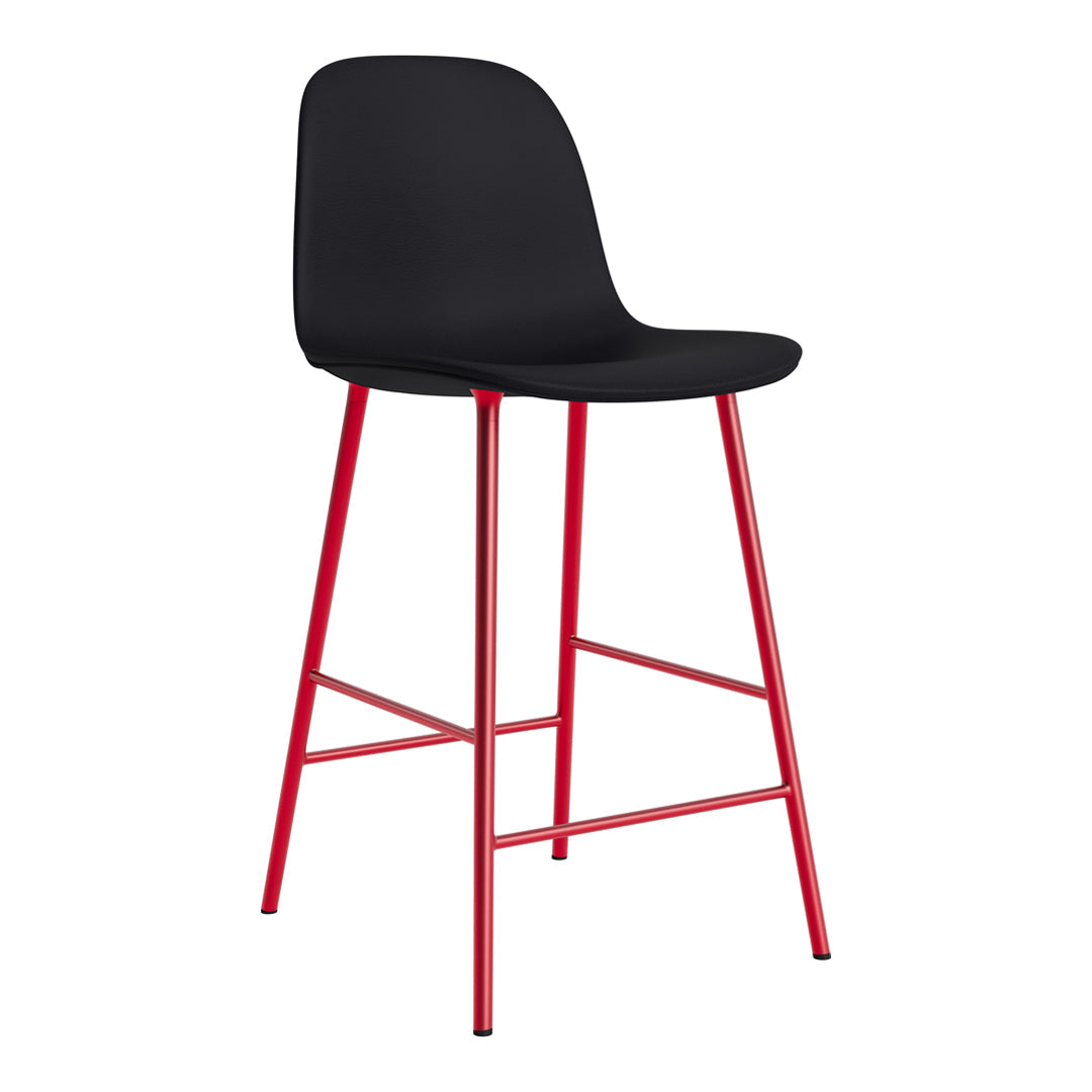 Modern black bar stool with a sleek, curved seat and vibrant red metal legs for a stylish touch.