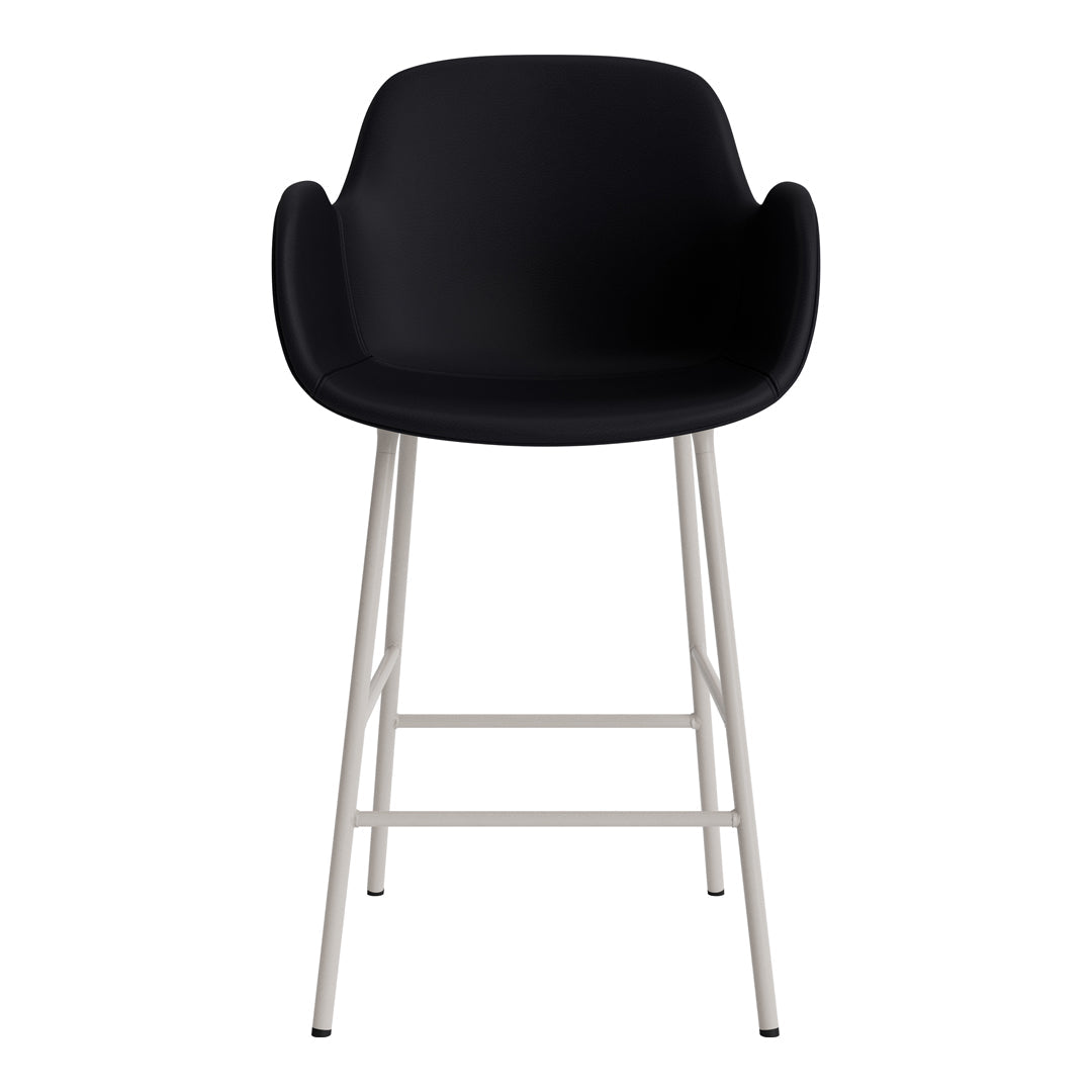 Black padded stool with sleek white metal legs, featuring a minimalist design and smooth surface. Perfect for modern decor.