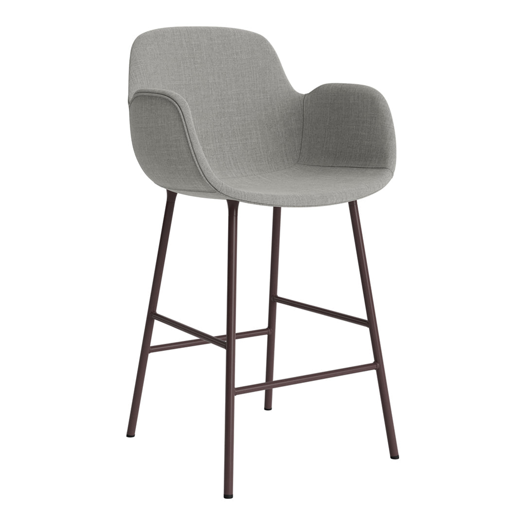 Grey upholstered bar stool with a sleek design and brown metal legs, perfect for modern interiors.