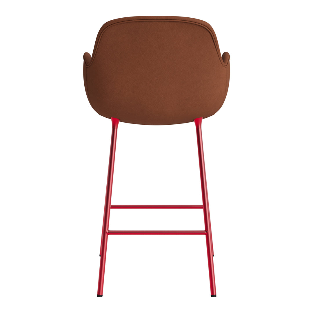 Brown upholstered bar stool with vibrant red metal legs, featuring a smooth, modern design.