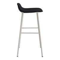 Black upholstered bar stool with sleek silver metal legs, modern design, and minimalist aesthetic.