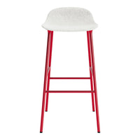 Red metal bar stool with a white, textured seat. Ideal for modern and vibrant decor.