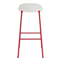 Red metal bar stool with a soft white upholstered seat, offering a modern and stylish design for any space.
