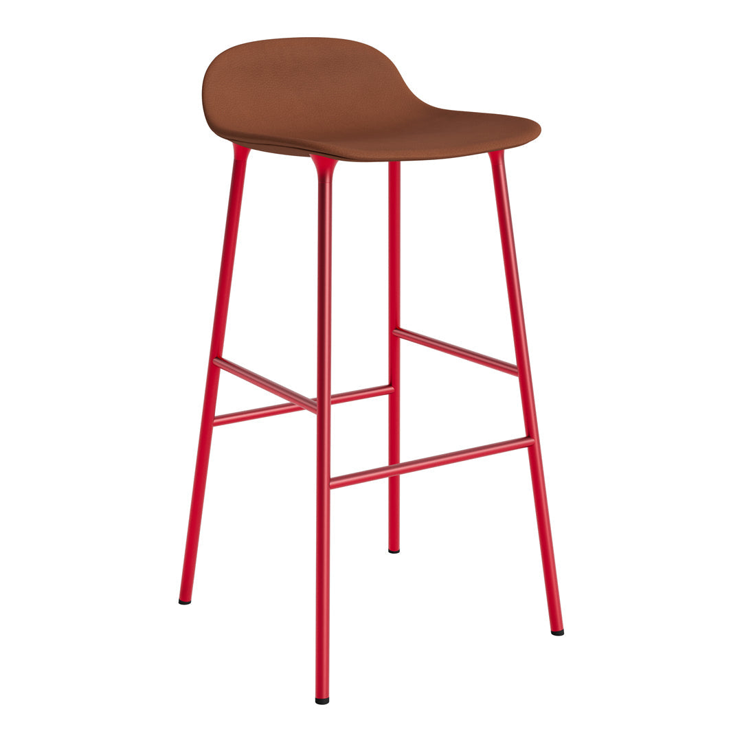 Brown padded seat with red metal legs; modern bar stool design, perfect for vibrant decor.