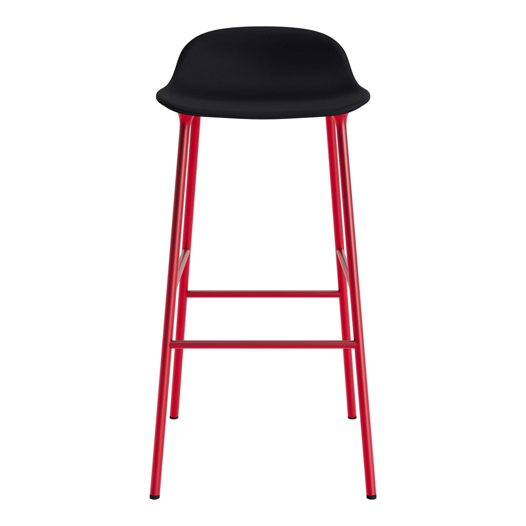 Black bar stool with a smooth seat and vibrant red metal legs. Modern design for stylish interiors.