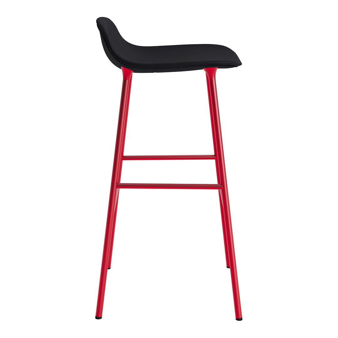 Black upholstered bar stool with sleek red metal legs, modern design, perfect for contemporary spaces.