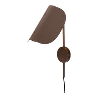 Brown wall lamp with a sleek, curved shade and minimalist design, featuring a smooth finish and modern aesthetics.