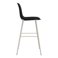 Black upholstered bar stool with sleek silver legs, featuring a minimalist design and smooth contours.