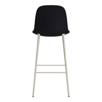 Black bar stool with a sleek design and light gray metal legs, showcasing a minimalist modern aesthetic.