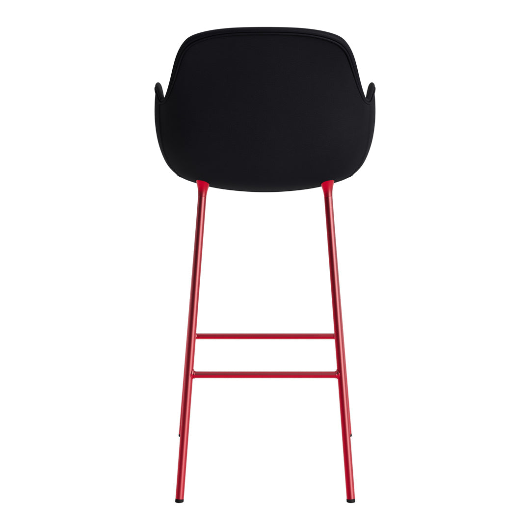 Black chair with a sleek bowl-shaped seat and vibrant red legs, featuring a modern minimalist design.