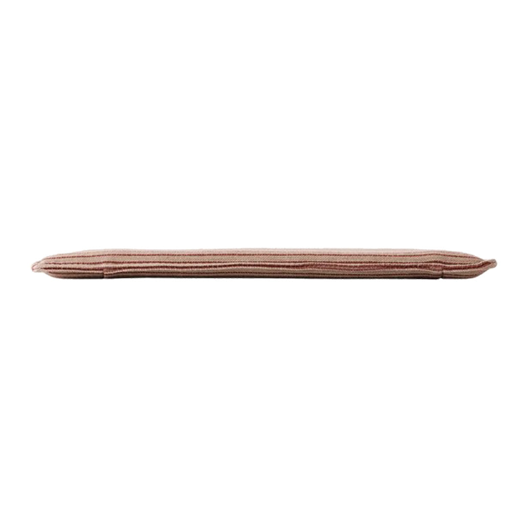 Long cushion in soft, muted pink with subtle vertical stripes, adding a touch of elegance to home decor.
