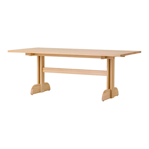 Light wood dining table with a smooth, natural finish and minimalistic design, showcasing clean lines and simple shapes.