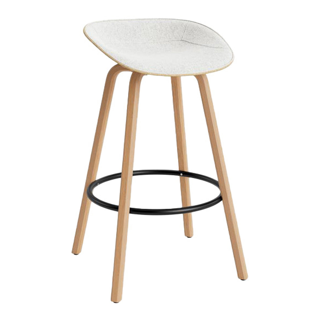White speckled seat with natural wood legs and a black metal footrest, modern and minimalist design.