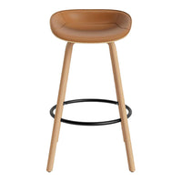 Tan leather bar stool with natural wood legs and black metal footrest, featuring a smooth, minimalist design.