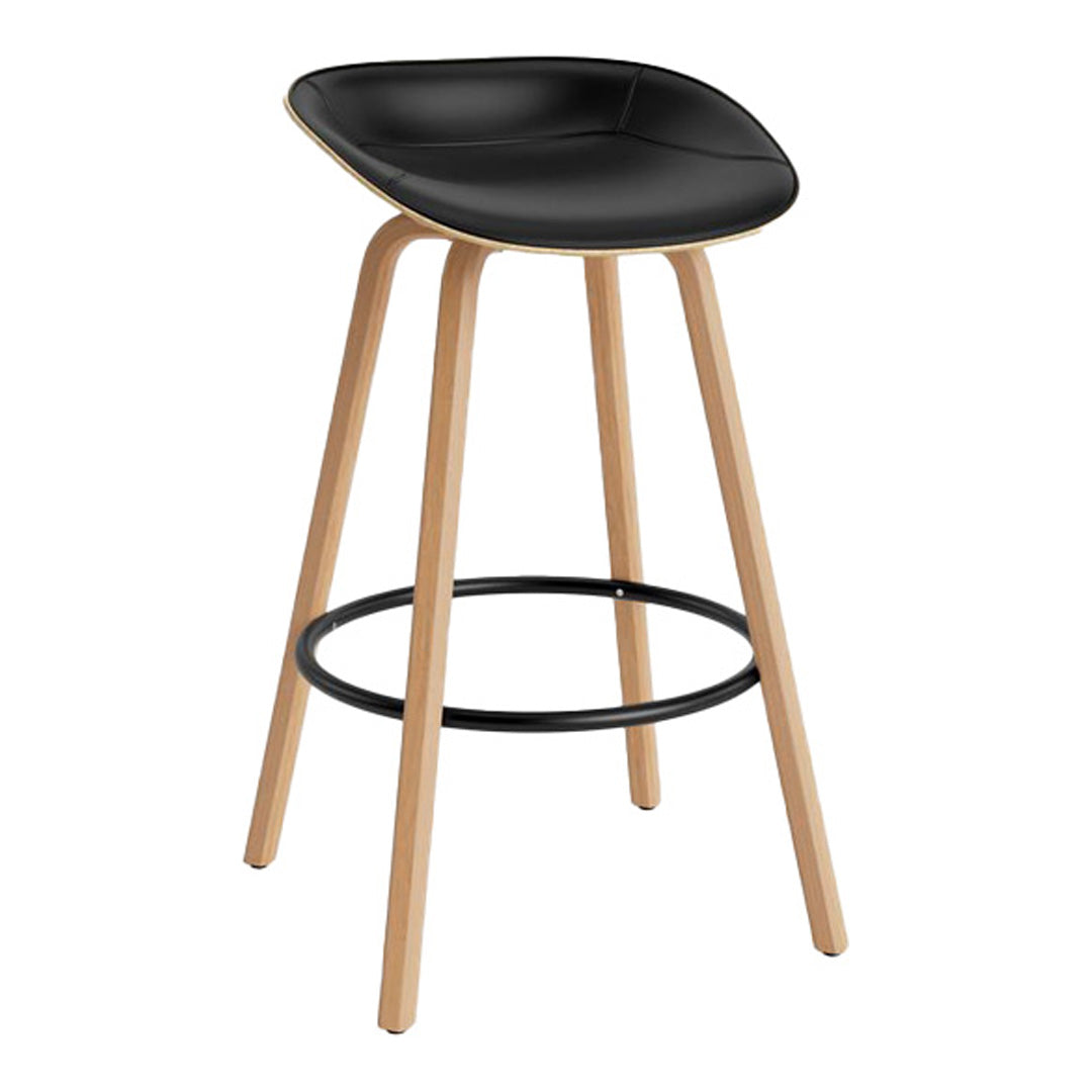 Black upholstered stool with natural wood legs and a sleek, modern design. Features a black circular footrest.