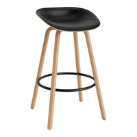 Black upholstered stool with natural wood legs and a sleek, modern design. Features a black circular footrest.