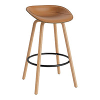 Tan curved seat barstool with natural wooden legs and a sleek black footrest. Modern design for any space.