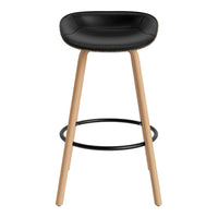 Black upholstered bar stool with natural wood legs and a sleek, modern design. Perfect for contemporary spaces.
