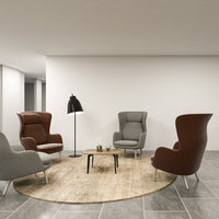 Stylish chairs in rich brown and soft gray, paired with a beige round rug, against a modern gray tile floor.