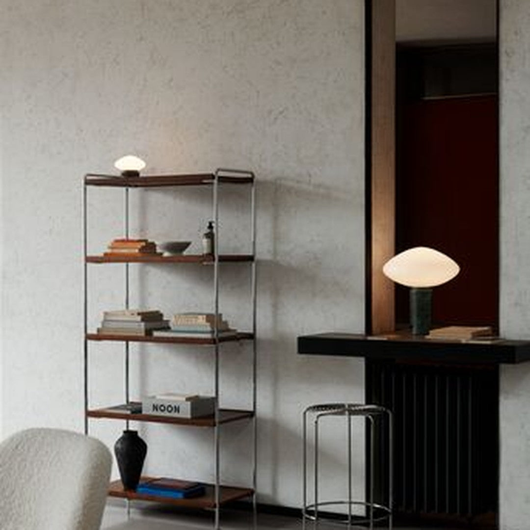 Modern bookshelf with wooden shelves, sleek metal frame, and subtle neutral tones, enhancing contemporary decor.