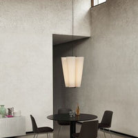 Elegant pendant lamp featuring a soft beige color and smooth, minimalist design against a textured gray wall.