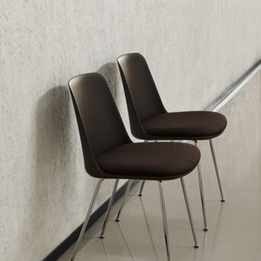 Brown upholstered chairs with sleek, modern design and chrome legs, set against a neutral textured background.